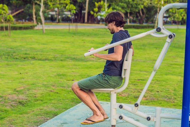 Hombre en el gimnasio de la calle en el parque.