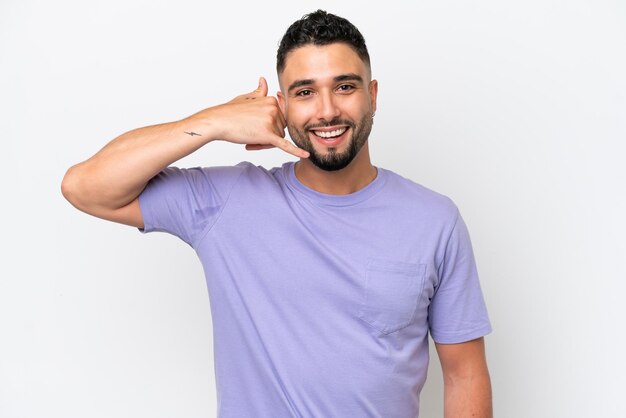 Hombre guapo árabe joven aislado sobre fondo blanco haciendo gesto de teléfono Llámame de nuevo signo