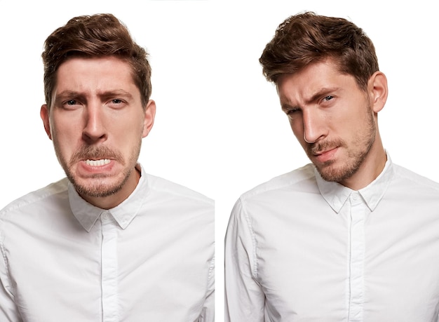 Hombre guapo con una camisa blanca hace muecas, aislado en un fondo blanco.