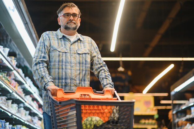 Hombre guapo de compras en un supermercado