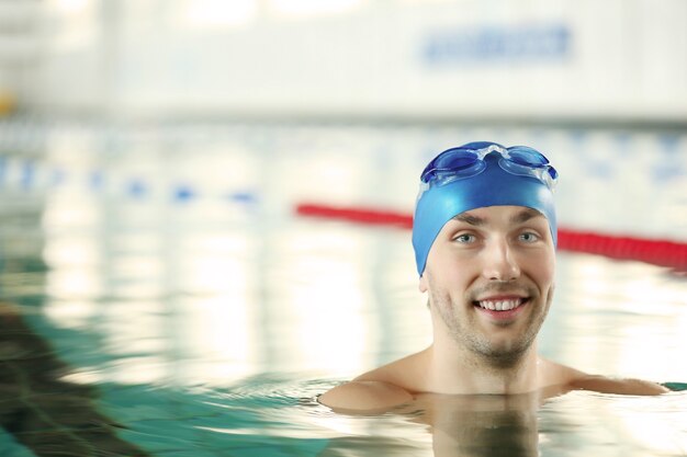 Hombre guapo deportivo en la piscina