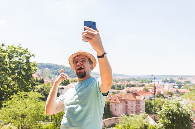 Hombre guapo está tomando un selfie al aire libre gente caucásica naturaleza personas estilo de vida y tecnología