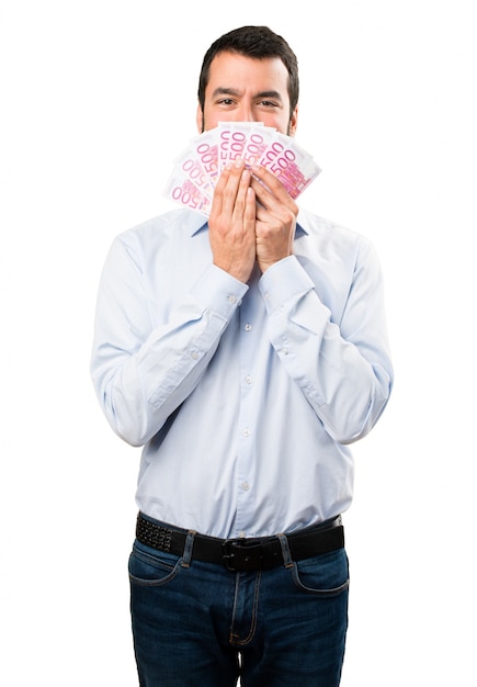 Hombre guapo feliz con barba tomando mucho dinero