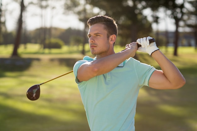 Hombre guapo golfista tomando tiro