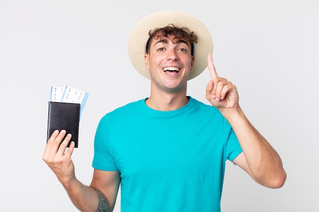 Hombre guapo joven que se siente como un genio feliz y emocionado después de darse cuenta de una idea. viajero sosteniendo su pasaporte