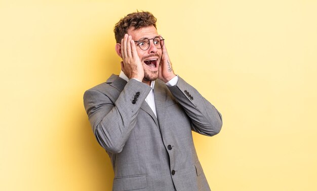 Hombre guapo joven que se siente feliz, emocionado y sorprendido. concepto de negocio