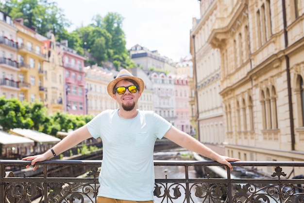 Hombre guapo joven en la vieja ciudad europea viajero verano gente y concepto de viaje
