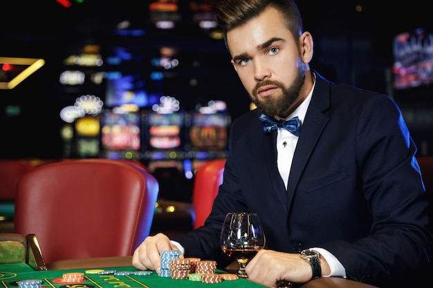 Hombre guapo jugando a la ruleta en el casino