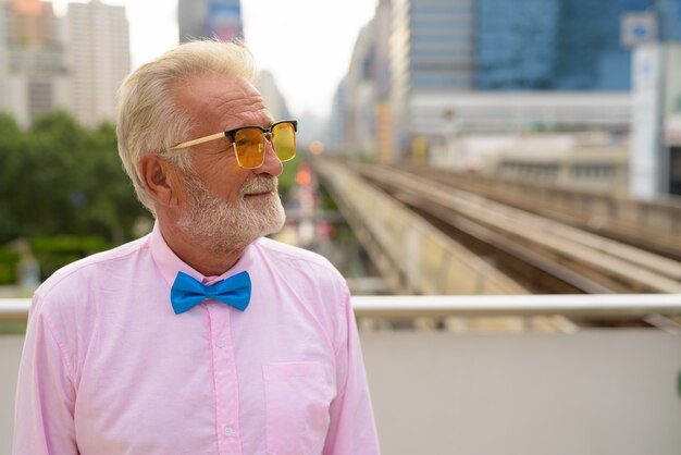 Hombre guapo turista senior explorando la ciudad de Bangkok, Tailandia