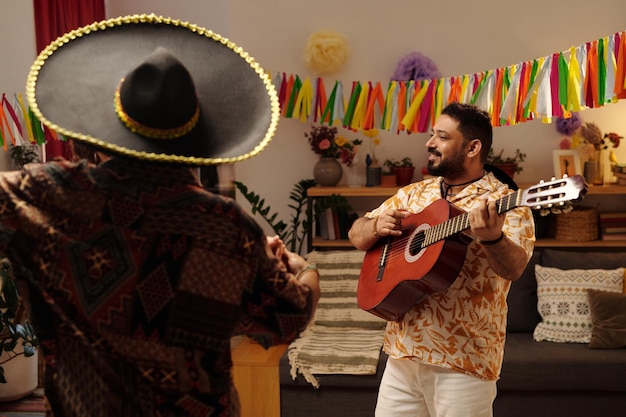 Hombre con guitarra y pareja bailando