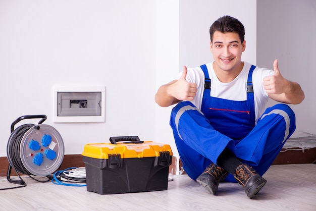 Hombre haciendo reparaciones eléctricas en casa