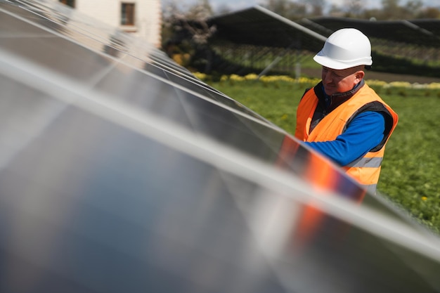 Hombre inspeccionando paneles en una planta de energía solar