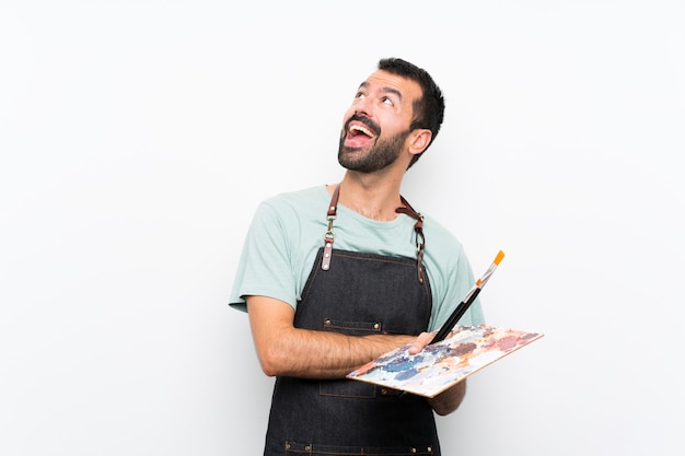 Foto hombre joven artista sosteniendo una paleta