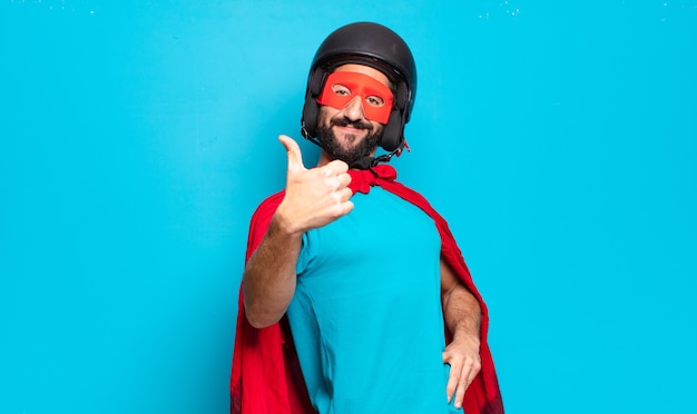 Hombre joven con barba. superhéroe loco y humorístico con casco y máscara