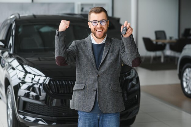 Hombre joven con las llaves en el coche