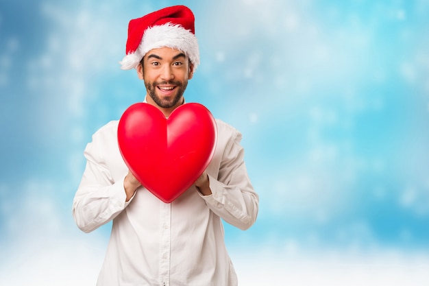 Hombre joven con un sombrero de santa claus en el día de Navidad