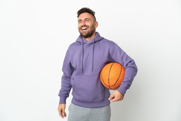 Hombre de jugador de baloncesto aislado en blanco riendo