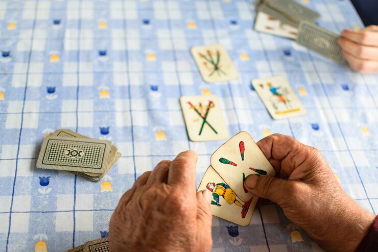 Un hombre jugando a las cartas con un juego de cartas de naipes.