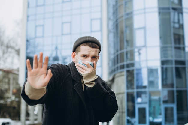 Un hombre con una máscara en la calle. Protección contra virus y agarre