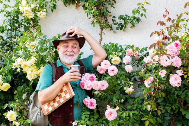 Hombre mayor relajándose en su jardín Jardinero mayor está disfrutando de su trabajo en el jardín