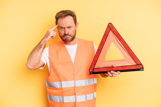 hombre de mediana edad que se siente confundido y perplejo, mostrando que está loco ... concepto de automóvil de descomposición triangular