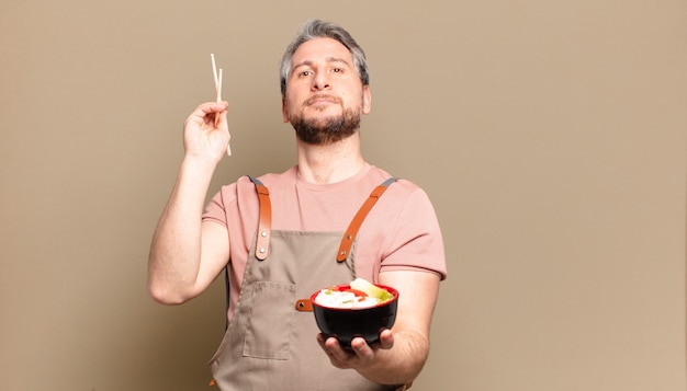 Hombre de mediana edad con un tazón de ramen