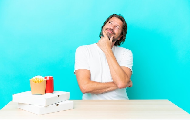 hombre en la mesa sobre un fondo azul aislado