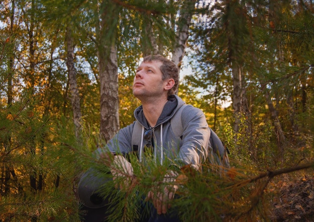 Hombre mirando lejos en el bosque