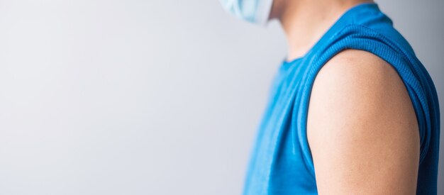 Hombre mostrando su brazo con vendaje después de recibir la vacuna