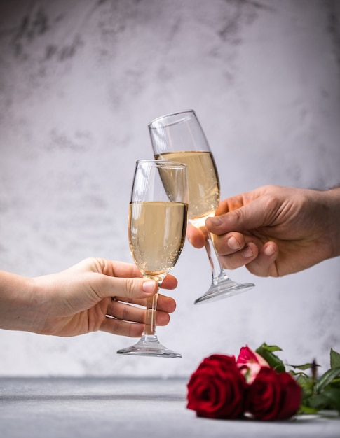 Foto hombre y mujer brindando con champán por el día de san valentín