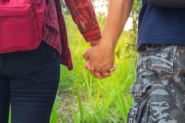 Hombre y mujer caminando de la mano, dos manos