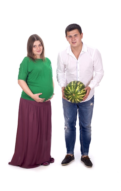 Un hombre y una mujer embarazada sostienen una gran sandía en sus manos
