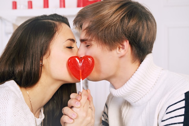 Hombre y mujer con una piruleta en forma de corazón