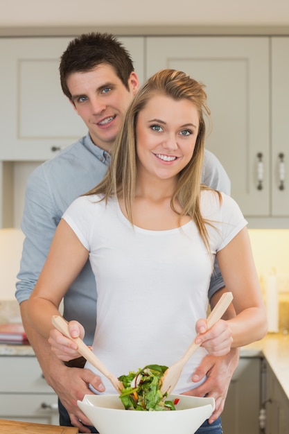 Hombre y mujer preparando una ensalada