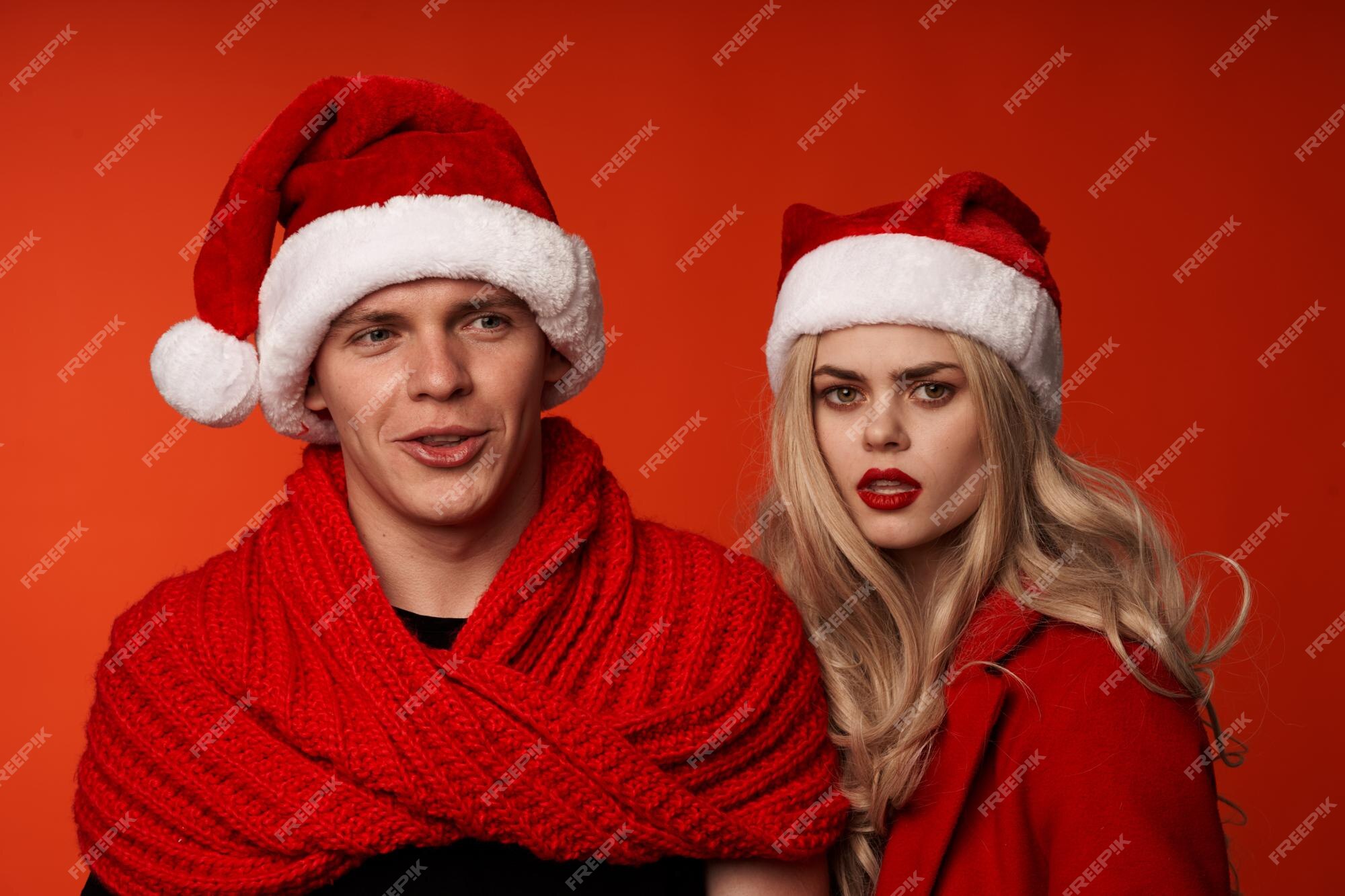 Hombre y mujer en ropa de año nuevo fondo rojo vacaciones de navidad | Foto Premium