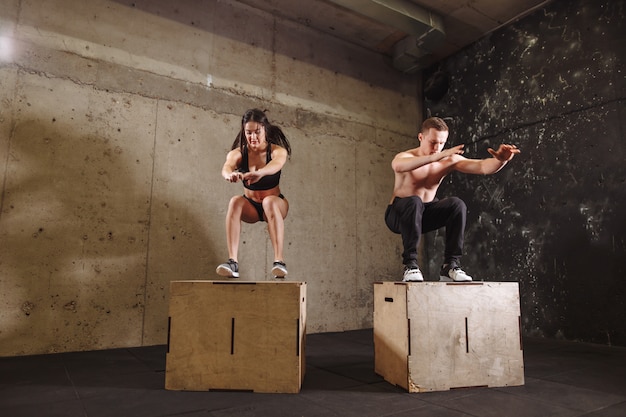 Hombre y mujer saltando en forma de caja