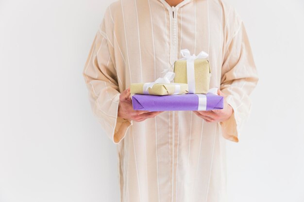hombre musulmán con cajas de regalos