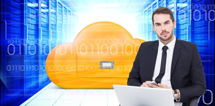 Foto hombre de negocios alegre con una computadora portátil usando un teléfono inteligente contra una imagen compuesta del cajón de la computación en la nube