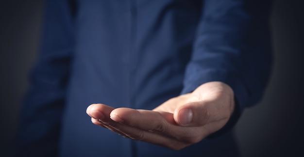 Hombre de negocios caucásico que muestra la mano vacía.