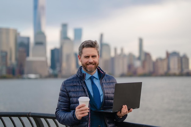 Hombre de negocios con chaqueta cálida bebiendo café en Nueva York hombre de negocios en invierno Nueva York Manhattan guapo