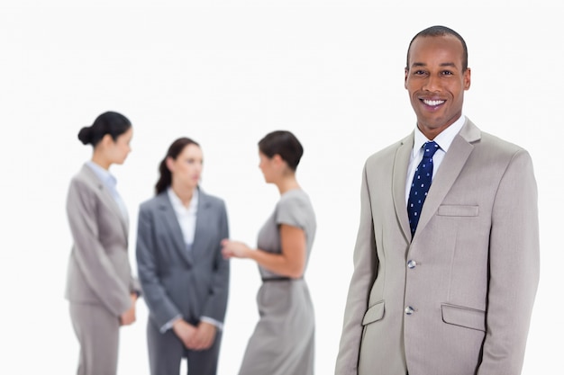 Hombre de negocios con compañeros de trabajo hablando en el fondo