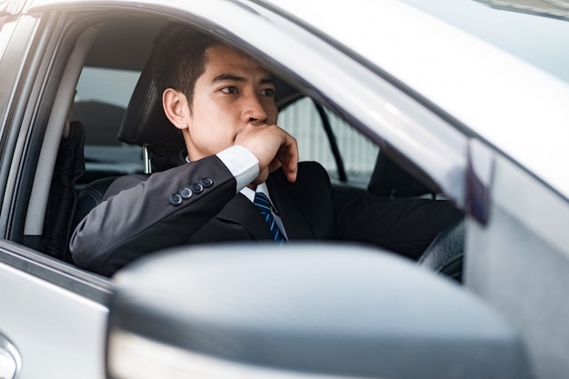 Hombre de negocios conduciendo un coche.