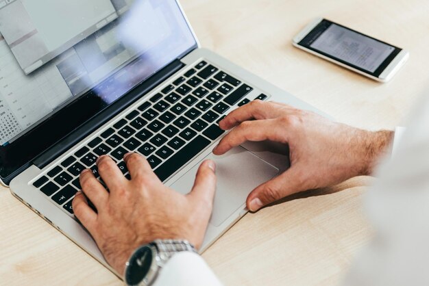 Un hombre de negocios escribiendo en el teclado.