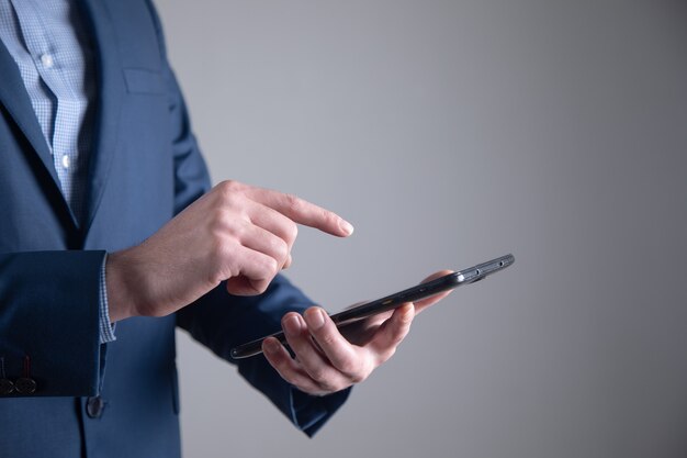 Hombre de negocios joven que sostiene la tableta digital.