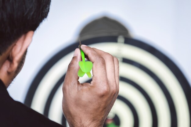 Foto el hombre de negocios está lanzando dardos a la meta por delante