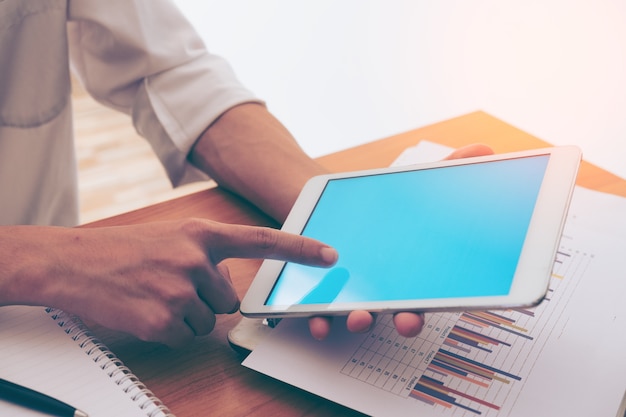 hombre de negocios manos sobre una mesa con tableta en una oficina