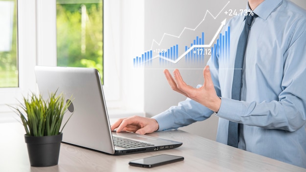 Hombre de negocios que sostiene la tableta y que muestra gráficos holográficos y estadísticas del mercado de valores obtiene ganancias. Concepto de planificación del crecimiento y estrategia empresarial. Visualización de pantalla digital de buena forma económica.