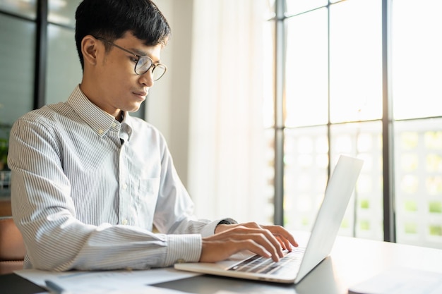 Hombre de negocios que trabaja con una computadora portátil Manos escribiendo teclado Inversor profesional que trabaja en la puesta en marcha del proyecto de planificación empresarial en la oficina Negocio de tecnología