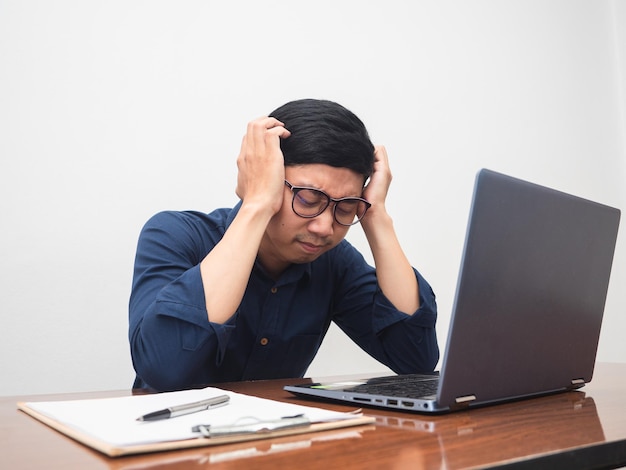 El hombre de negocios se siente probado con el gesto de trabajo, sostenga el dolor de cabeza del hombre con el trabajo duro