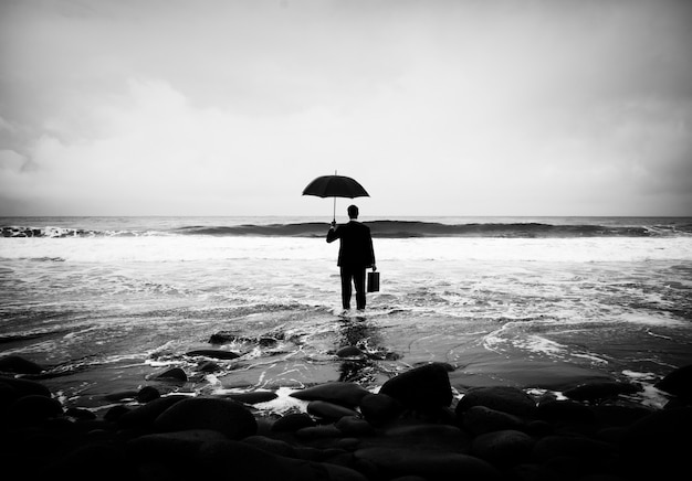 Hombre de negocios solitario solo en la playa